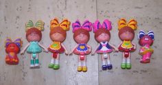 five little dolls are lined up on the floor