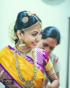 a woman wearing a yellow and purple sari