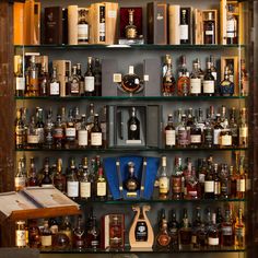 a shelf filled with lots of liquor bottles