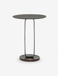 a round table with metal legs and a black top on a white background, it is standing upright