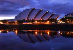 a large building sitting next to a body of water