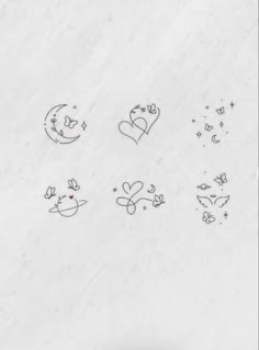 some drawings on the side of a snow covered wall with hearts and stars drawn on it