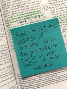 a piece of paper that has been placed on top of an open book with the words peace is not the presence of the presence