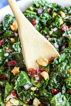 spinach salad with cranberries and walnuts in a white bowl