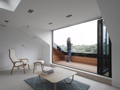 a living room filled with furniture and large windows