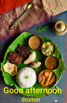 a plate with rice, meats and sauces on it sitting on a table