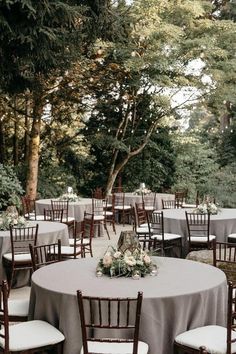 an outdoor wedding reception with tables and chairs