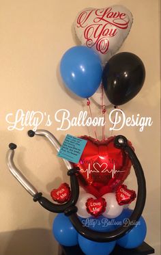 balloons and medical equipment are on display in a room with the name lilly's balloon design