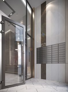 an empty elevator with metal doors and mailboxes on the wall next to it