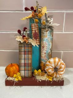 three decorative vases sitting on top of each other in front of a brick wall