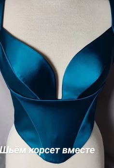 a close up of a mannequin wearing a blue bra with an open back