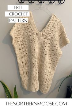 a knitted sweater hanging on the wall with text overlay that says free crochet pattern