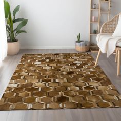 a living room area with a rug, chair and potted plant