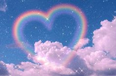 a heart shaped rainbow in the sky with stars and clouds around it on a sunny day