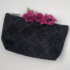 "Our gothic damask skull print t-bottom pouch is perfect to take on all your adventures this season. Sizes available from small to large and can be used for pretty much anything. This accessory bag is great to use as a pencil case or cosmetic travel bag. Constructed from a durable material with a gold zipper closure. - 100% Polyester - Multiple sizes - With non-woven laminate inside - With NOKTURNAL DOLL branding  Small Size Bag Size - Length 8.67\" x 2.37\" x Height 4.73\" Large Size Bag Size - Length 12.6\" x 3.15\" x Height 7.29\" Cleaning Instructions - Before cleaning the bag, remove all the items from bag. Suggested to pretreat visible stains with stain remover. Mix warm water with laundry detergent and clean the bag with terry washcloth or soft bristle brush. Let the bag air dry. Co Witchy Bag, Gothic Bag, Skull Accessories, Skull Makeup, Cosmetics Bag, Zippered Pouch, Soft Bristle Brush, Travel Cosmetic Bags, Coin Purses