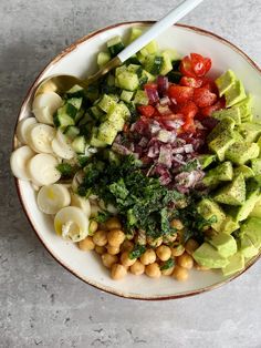 a white bowl filled with different types of food on top of a gray countertop