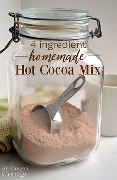 homemade hot cocoa mix in a glass jar with a measuring spoon on the side and text overlay that reads, 4 ingredient homemade hot cocoa mix