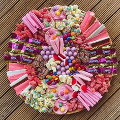 a plate filled with candy and candies on top of a wooden table