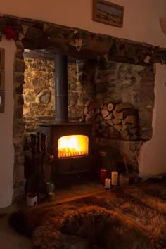 a wood burning stove in a stone walled room