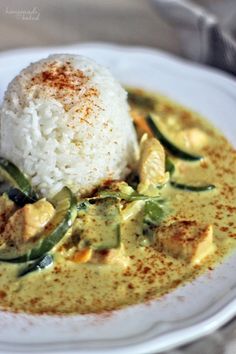 a white plate topped with rice and veggies