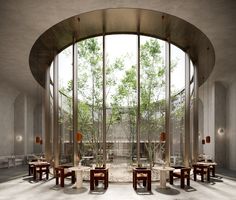 the interior of a restaurant with tables and chairs in front of large round glass windows