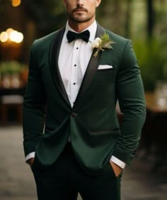 a man wearing a green suit and bow tie