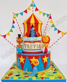 a circus themed birthday cake with clowns and bears on it's top tier