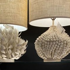 two lamps made out of paper balls are on display