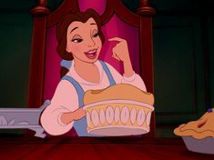 an image of a woman that is holding a cake in front of her face with the words disney written on it