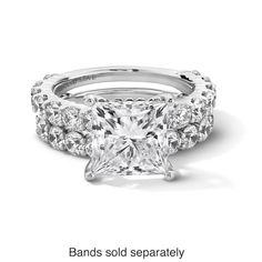 a princess cut diamond engagement ring with three side stones on the band and two rows of diamonds