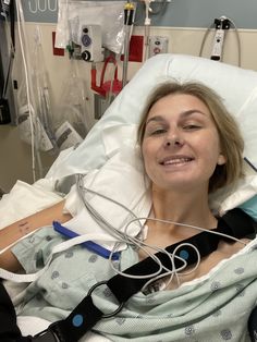 a woman laying in a hospital bed with an oxygen tube attached to her arm and head