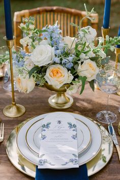 an elegant table setting with blue and white flowers