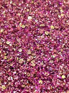 pink and gold glitter flakes are scattered on the ground in this close up photo