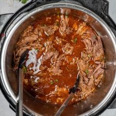 a large pot filled with meat and sauce