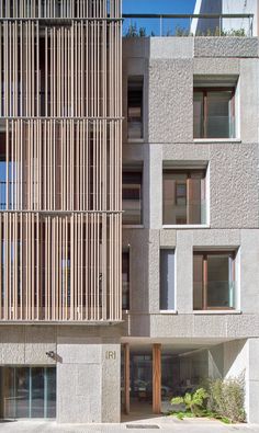 an apartment building with wooden slats on the facade