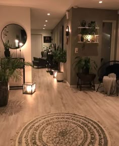 a living room filled with lots of furniture and decor on top of wooden flooring