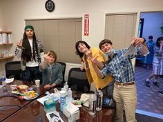 a group of people standing around a conference room table