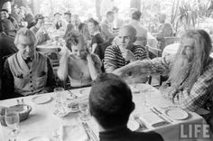 a group of people sitting around a table eating food