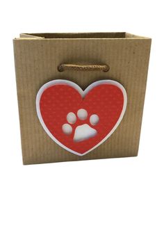 a cardboard box with a red heart and paw prints on it