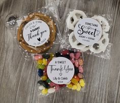 three candy bags filled with candies on top of a wooden table