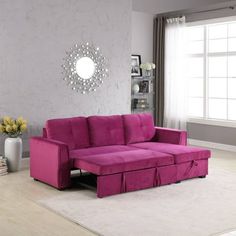 a living room with a fuchsia colored couch and white rug on the floor