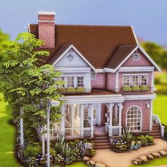 a large pink house sitting on top of a lush green field