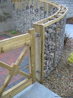 a wooden gate with rocks in it