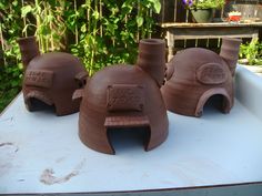 four clay pots sitting on top of a table