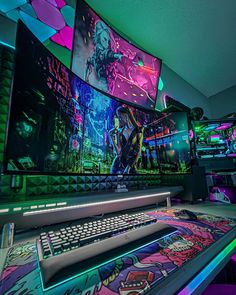 a room filled with lots of computer screens next to a keyboard and monitor on top of a desk