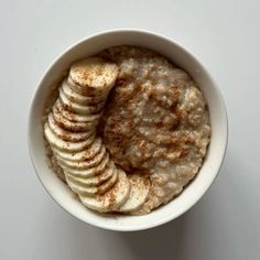 a bowl filled with oatmeal and sliced bananas