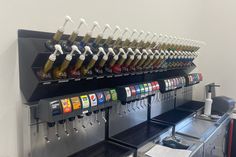 a row of beer taps on the side of a wall