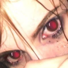 a close up of a person with red eyes