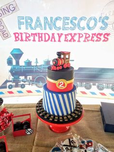 a train themed birthday cake on a table