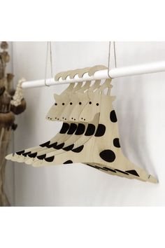 three pieces of wood hanging from a white wall